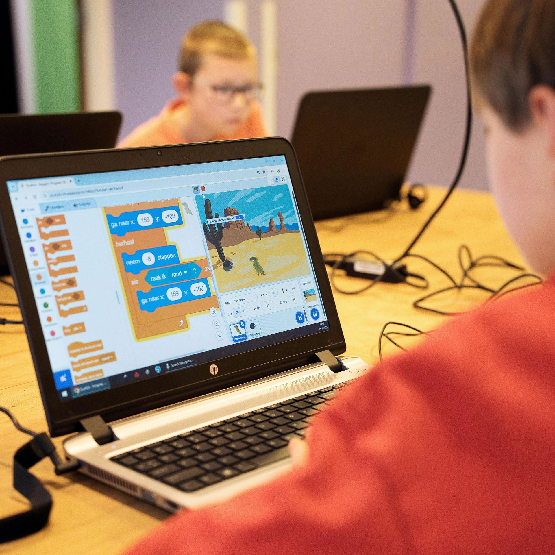 Boy plays Scratch on the laptop