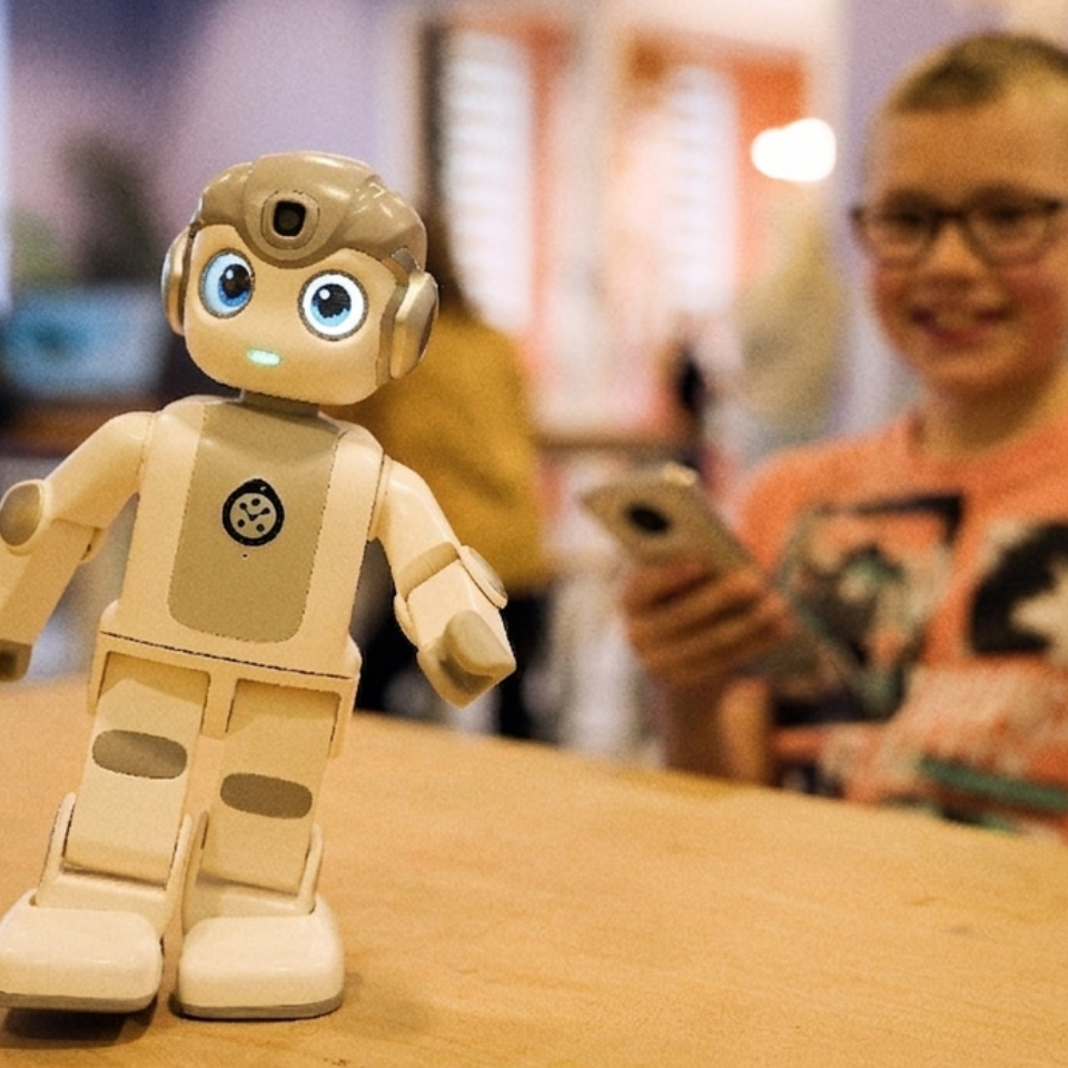 Boy plays with robot in the NXT Lab